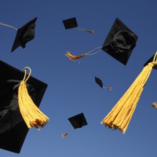 grad hats in air