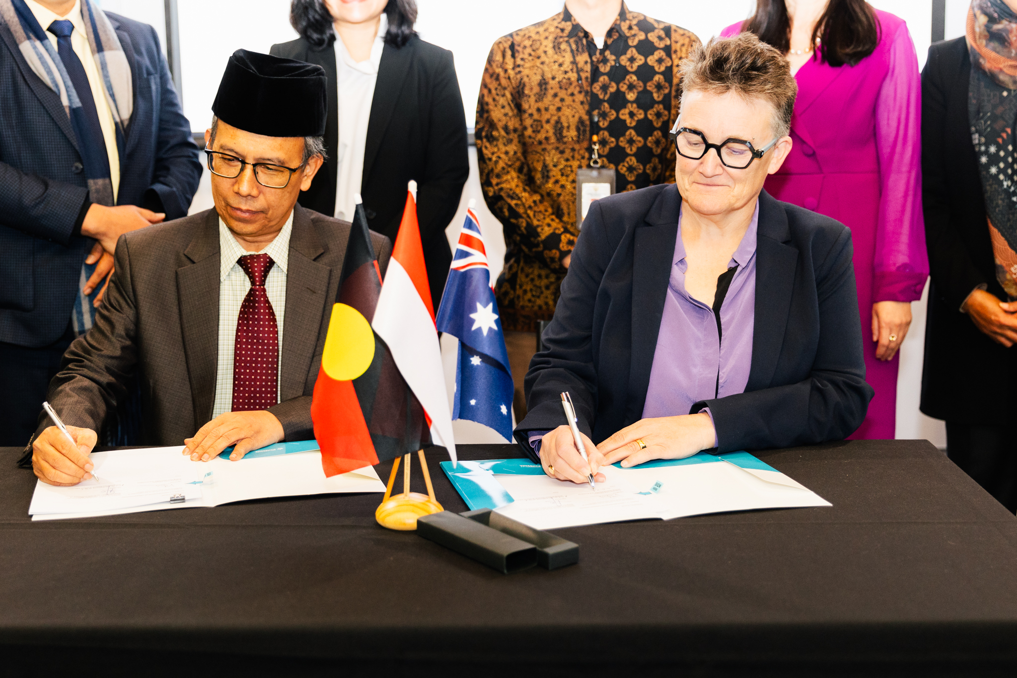 Man and woman sign official documents