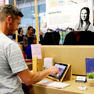 Image of a man looking at work at the graduate exhibition