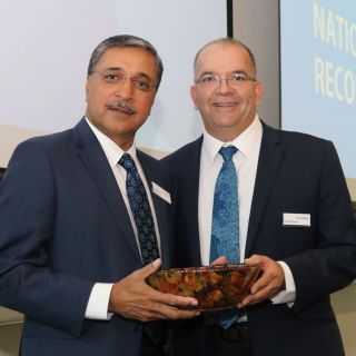 The Dean of Aboriginal and Torres Strait Islander Leadership and Strategy, Professor Peter Radoll, presents the Vice-Chancellor and President, Professor Deep Saini, with a wooden bowl that represents the unbreakable commitment from the University to reconciliation.