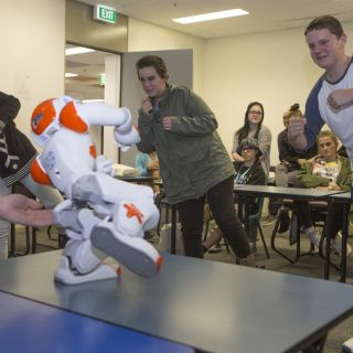 Taylan Bruce, Teagan Kindeysides and Kai Batten from Wagga’s Mount Austin High School take a Tai Chi lesson from the University of Canberra’s robot Ardie. Photo: Michelle McAulay