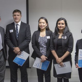 Minister Shane Rattenbury (left) congratulates UC students Phillip MacDougall, Karen Muga, Kirandeep Goraya and Janet Johnson on their Univative Canberra Challenge project win