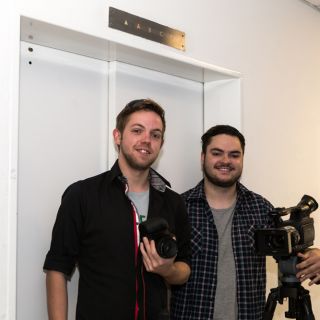 Film production students Cameron Griffith and James Christie-Murray standing in front of an elevator