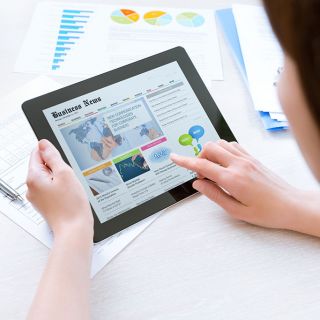 Image of woman accessing news on a digital device