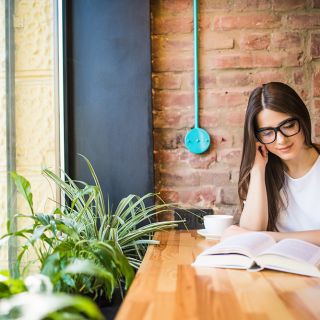 Girl reading book in coffee shop