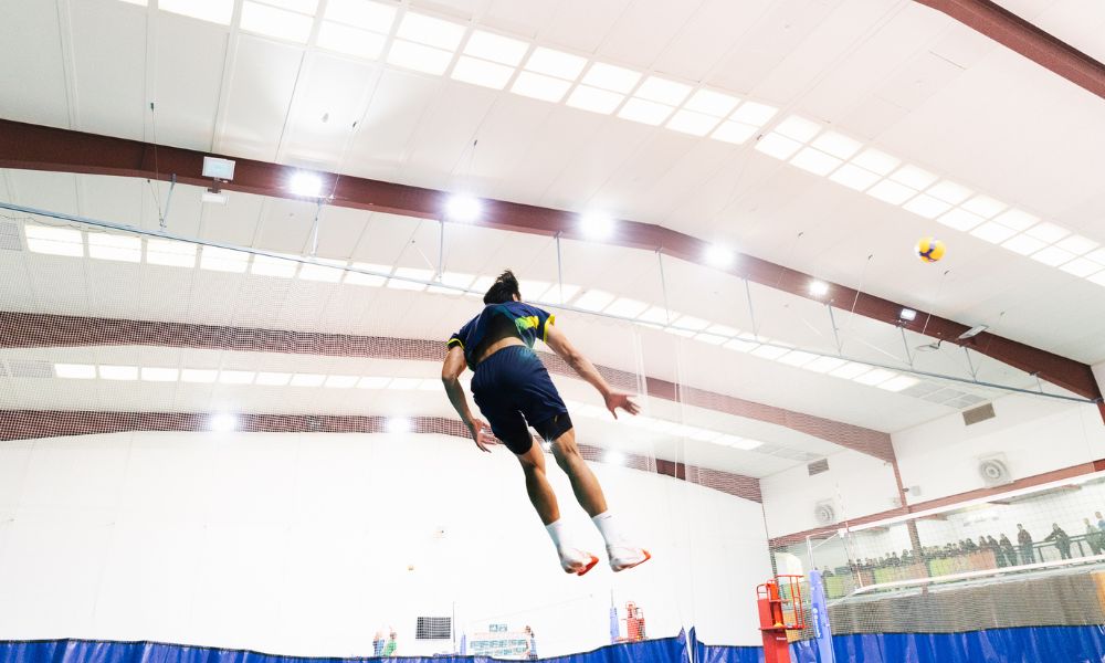 Seth Chen serving a volleyball