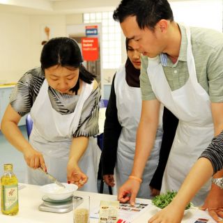 Students prepare a roast vegetable, egg, feta cheese and rice salad