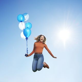 Jumping with balloons on campus