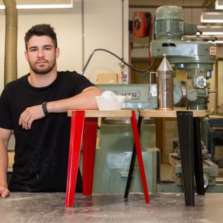 Industrial design student René Linssen winner of the Vogue Living Alessi Emerging Designer Prize standing in the workshop with some of his designs